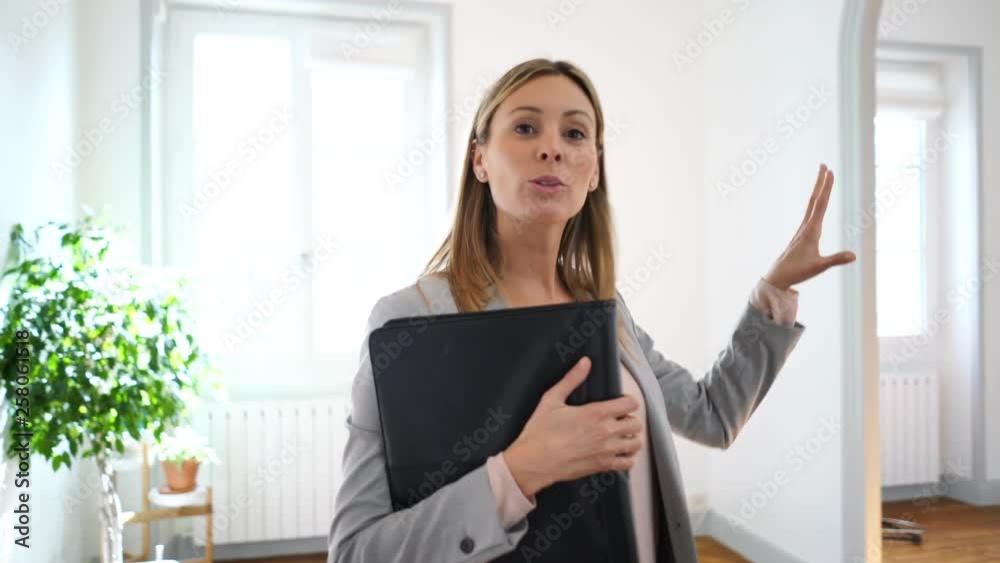 Real estate agent talking to camera guiding you through property Real estate agent talking to camera guiding you through property