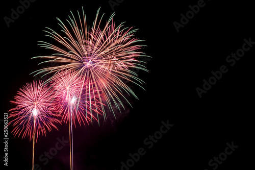 Amazing beautiful colorful fireworks display on celebration night  showing on the sea beach with multi color of reflection on water