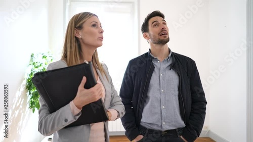 Female real estate agent showing spacious property to buyer