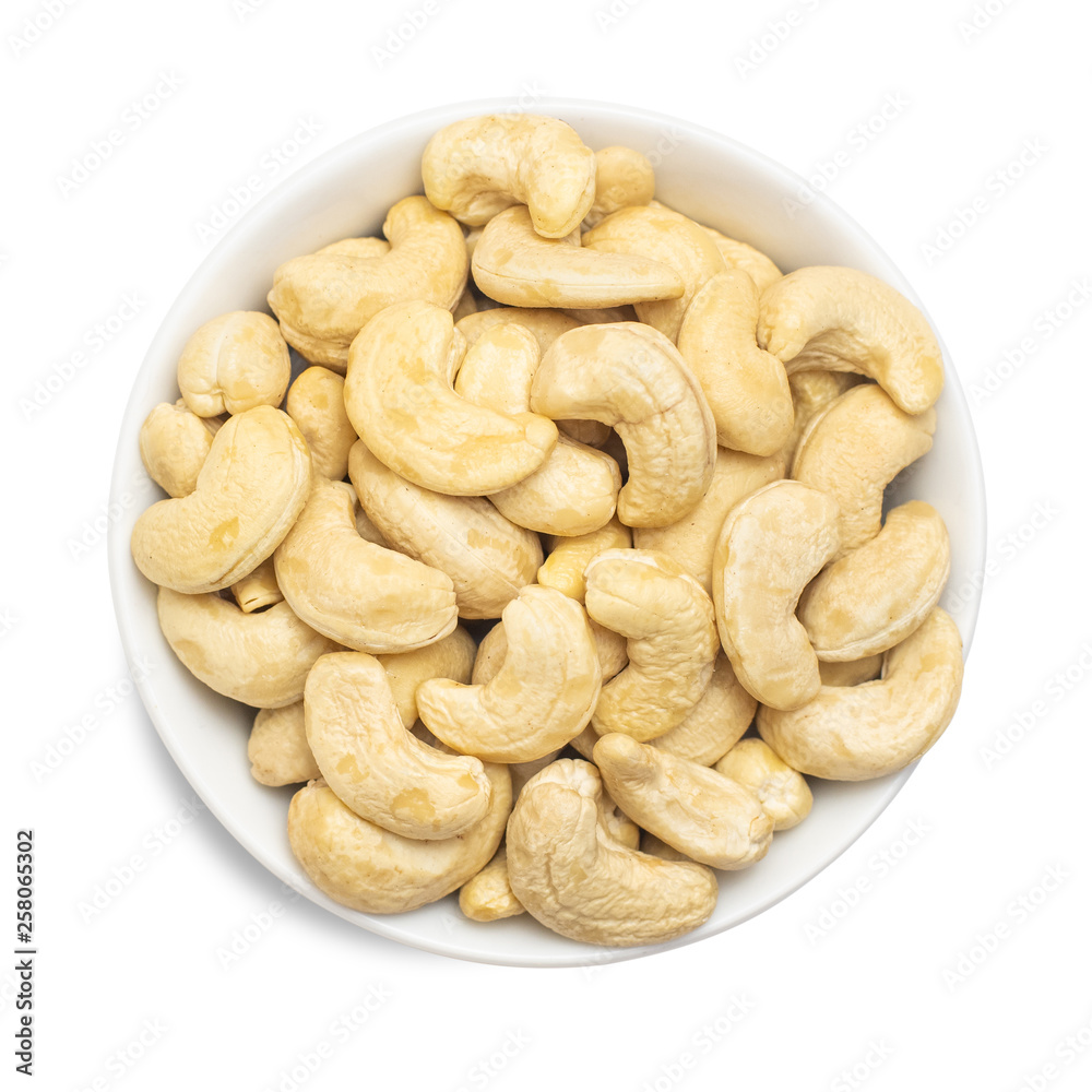 Whole cashews in bowl isolated on white background. Top view Whole cashews in bowl isolated on white background. Top view