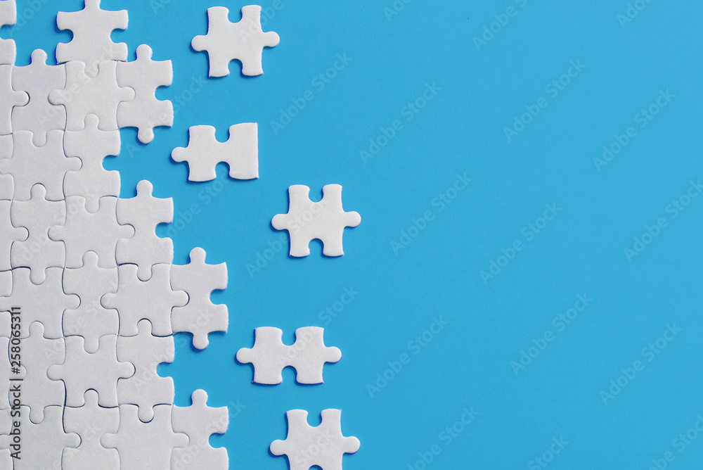 White details of puzzle on blue background - obrazy, fototapety, plakaty 