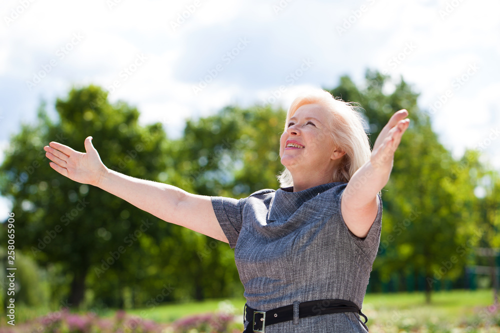 Happy elderly woman on the background of summer park Happy elderly woman on the background of summer park