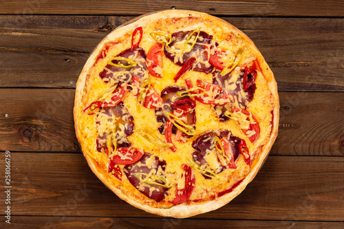 Appetizing pizza on a wooden background