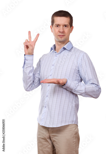 The man in a shirt shows gesture a victory