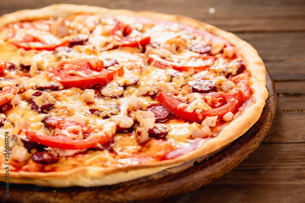 Appetizing pizza on a wooden background