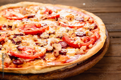 Appetizing pizza on a wooden background