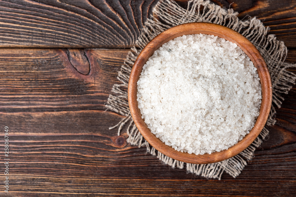 Sea salt on dark wooden background. Sea salt on dark wooden background.