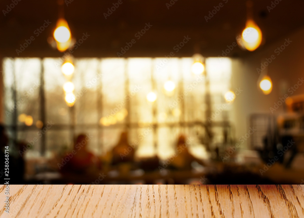 top of wood table with blur lamp and window light in the restaurant background