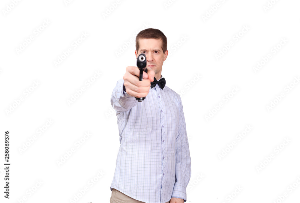 The man in a light shirt and in a tie butterfly, aims from a gun The man in a light shirt and in a tie butterfly, aims from a gun