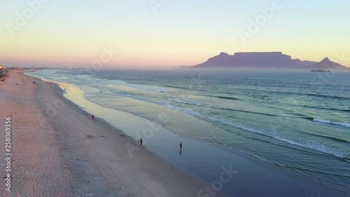 Aerial view of sunset on Cape Town beach with table mountain in the background