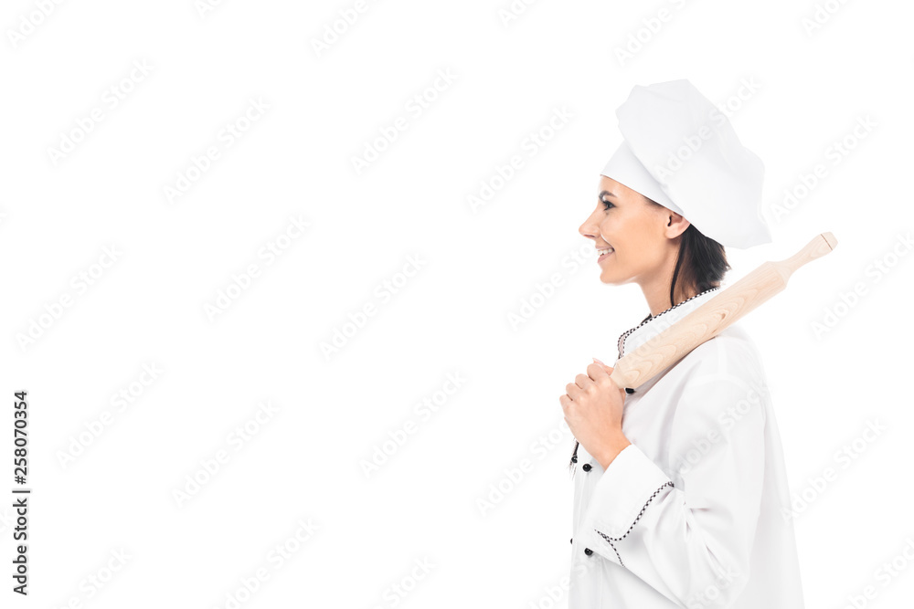 Side view of chef in hat holding rolling pin isolated on white Side view of chef in hat holding rolling pin isolated on white