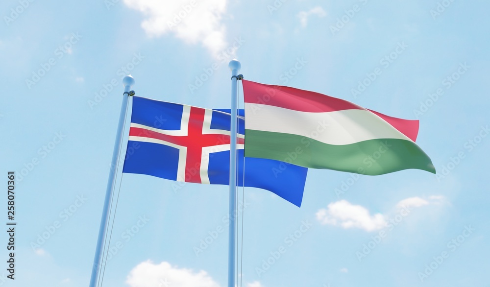 Hungary and Iceland, two flags waving against blue sky. 3d image