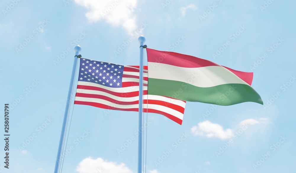Hungary and USA, two flags waving against blue sky. 3d image Hungary and USA, two flags waving against blue sky. 3d image