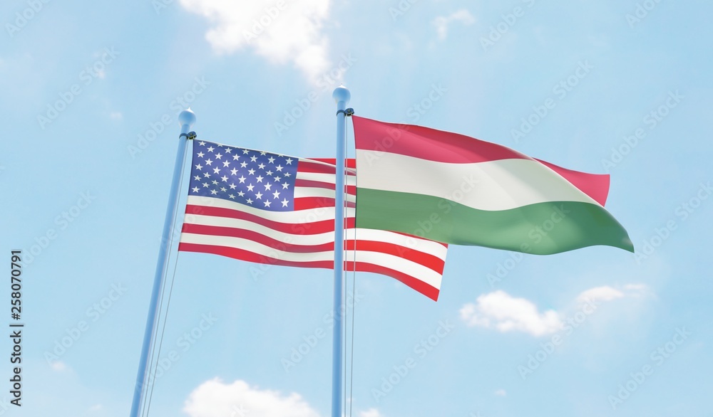 Hungary and USA, two flags waving against blue sky. 3d image