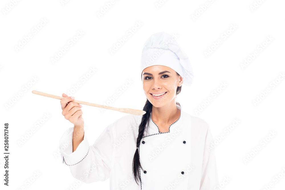 Smiling chef in hat holding wooden spatula isolated on white Smiling chef in hat holding wooden spatula isolated on white