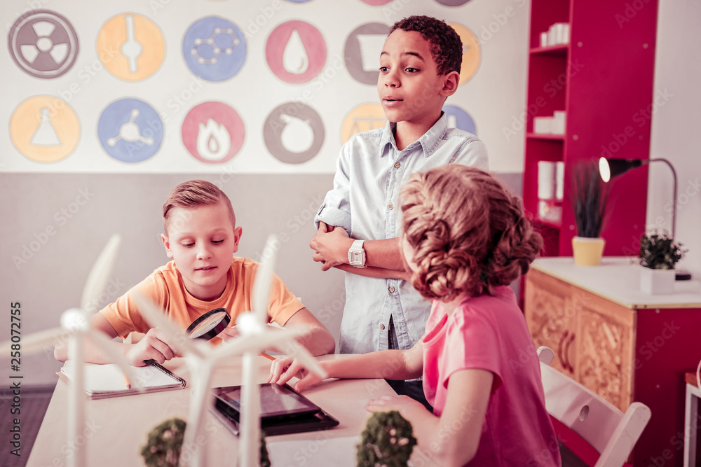 Fototapeta premium Little students sitting in class room and playing