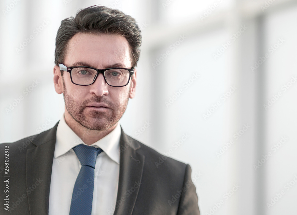 serious businessman on the background of the office window serious businessman on the background of the office window