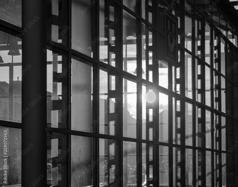 Reflection of the setting sun in the fully glazed facade of a high-rise building. Reflection of the setting sun in the fully glazed facade of a high-rise building.