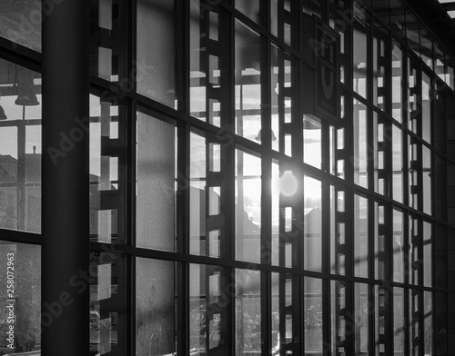 Reflection of the setting sun in the fully glazed facade of a high-rise building.