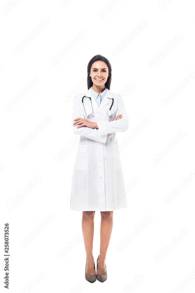 Full length view of joyful doctor in white coat standing with folded arms isolated on white Full length view of joyful doctor in white coat standing with folded arms isolated on white