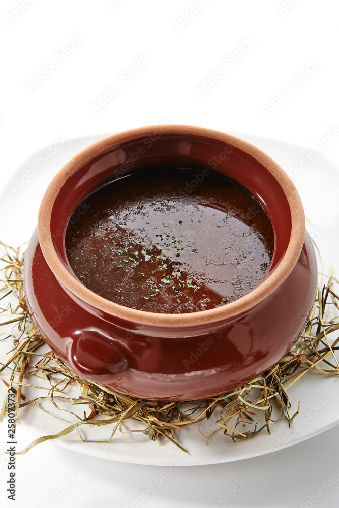 Rich Rustic Soup in Clay Pot on Fragrant Dry Hay Rich Rustic Soup in Clay Pot on Fragrant Dry Hay