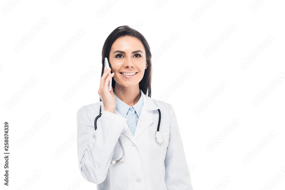 Doctor in white coat with stethoscope talking on smartphone isolated on white Doctor in white coat with stethoscope talking on smartphone isolated on white