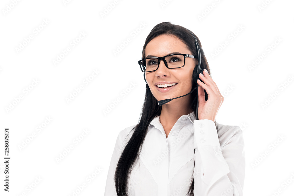 Smiling call center operator in glasses touching headset isolated on white Smiling call center operator in glasses touching headset isolated on white