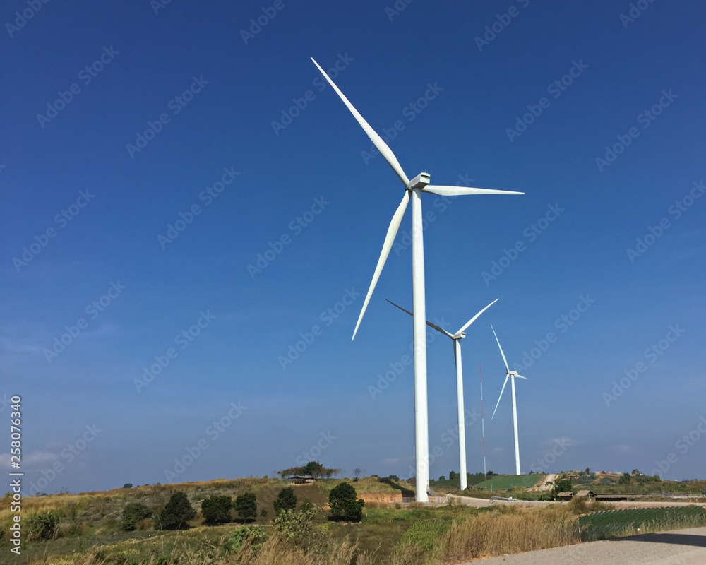 Wind turbines produce energy in the blue sky background Wind turbines produce energy in the blue sky background