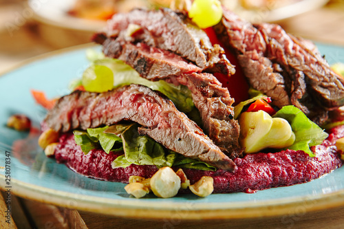 Salad with Grilled Prime Beef or Thick Slices of Marbling Steak on Blue Plate