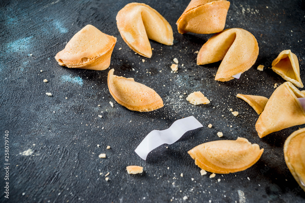 Chinese fortune cookie with prediction on dark blue concrete background copy space Chinese fortune cookie with prediction on dark blue concrete background copy space