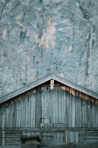 Cottage in front of a massive steep face