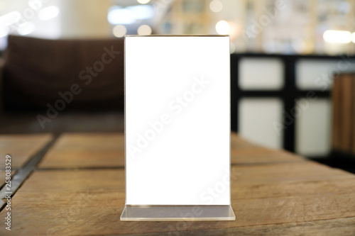 Menu frame space for text marketing promotion standing on wood table in Bar restaurant cafeใ