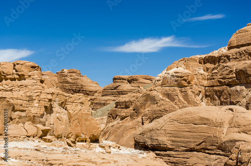 high rocky mountains in the desert against the blue sky and white clouds in Egypt Dahab South Sinai