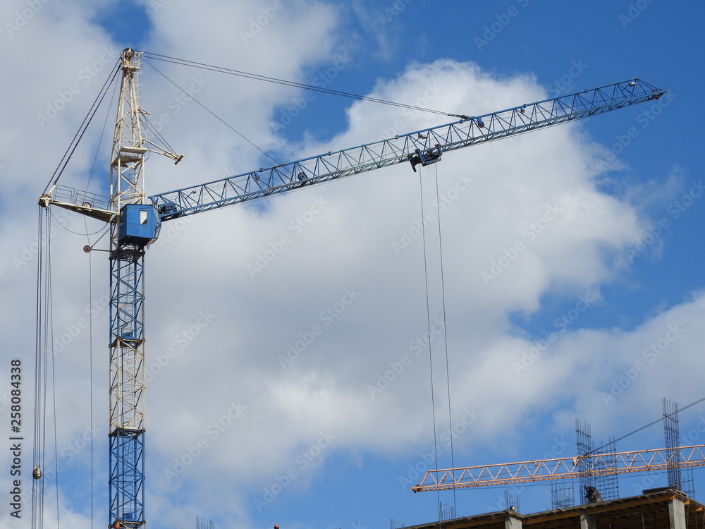 Tower cranes and their parts, construction of a new house. Tower cranes and their parts, construction of a new house.