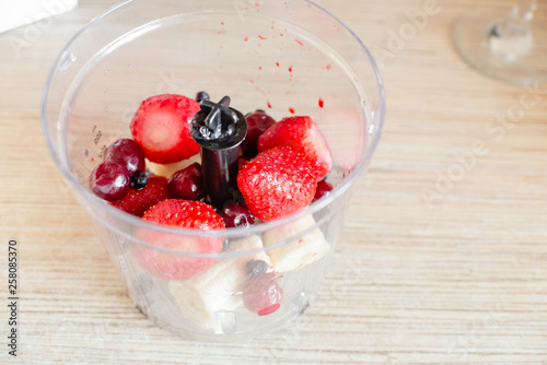 Ingredients for smoothie on wooden desk. Smoothies of strawberries ,blackberries,blueberries raspberry and cherries with yogurt.