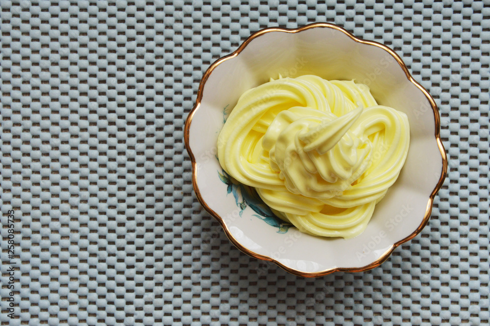 yellow dessert in a cream bowl yellow dessert in a cream bowl