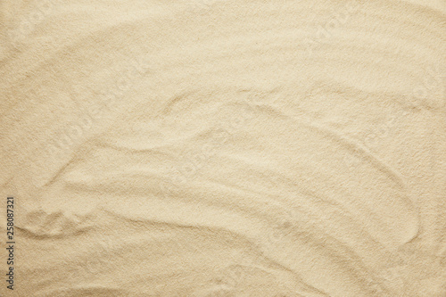 wavy, golden and textured sandy beach in summertime