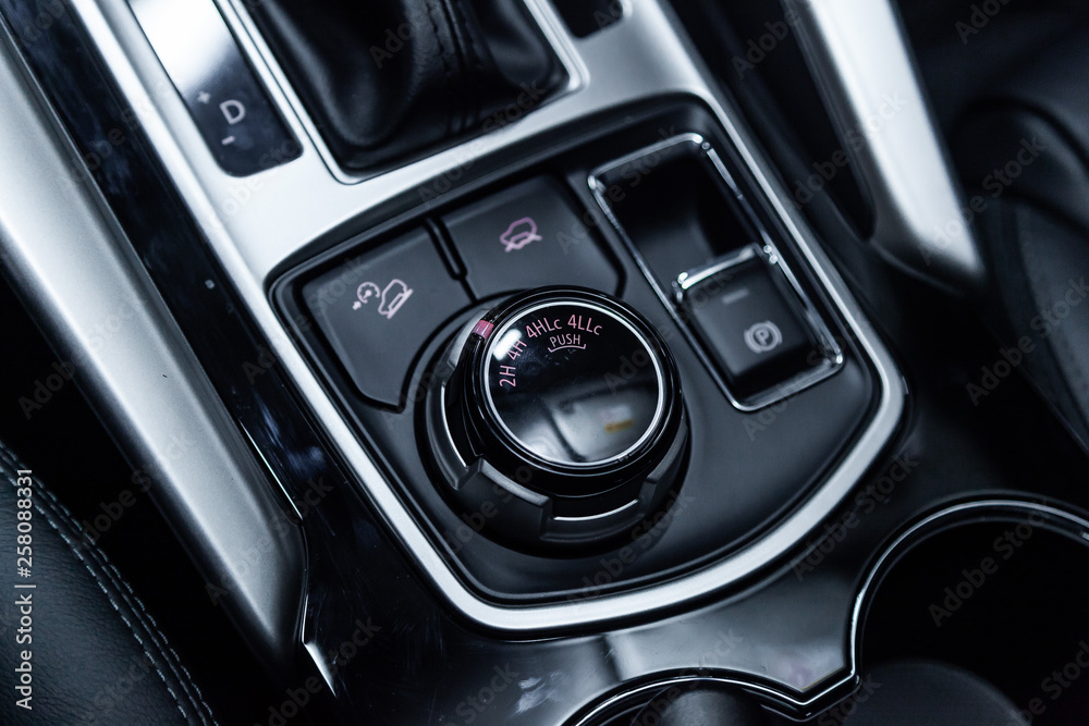 Сlose-up of the car  black interior:  4wd buttons, parking systems and other buttons .