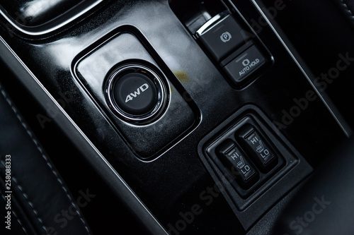 Foto Сlose-up of the car  black interior:  seat heating buttons, 4wd buttons, parking systems and other buttons