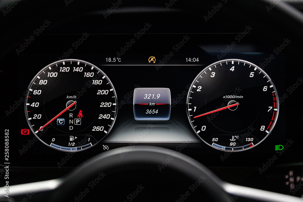 Сlose-up of the car  black interior:  dashboard, speedometer and tachometer and other buttons.