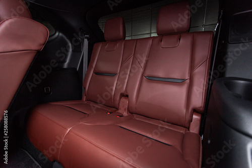 Сlose-up of the car  modern interior:  red leather rear seats and seat belts . © Виталий Сова