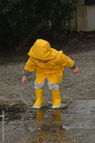 child in the rain with a yellow wax