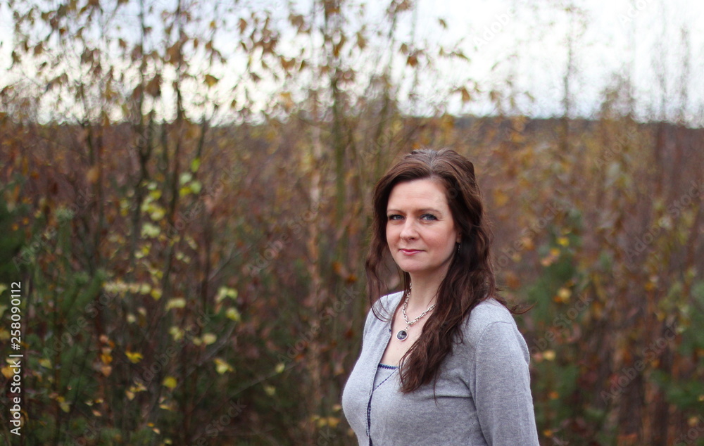 A woman in an autumn forest. A woman in an autumn forest.