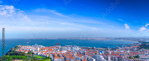 Summertime sunshine day panoramic cityscape view of Almada, Tagus river, Portugal.