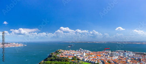 Summertime sunshine day panoramic cityscape view of Almada and Lisbon, Tagus river, Portugal. photo