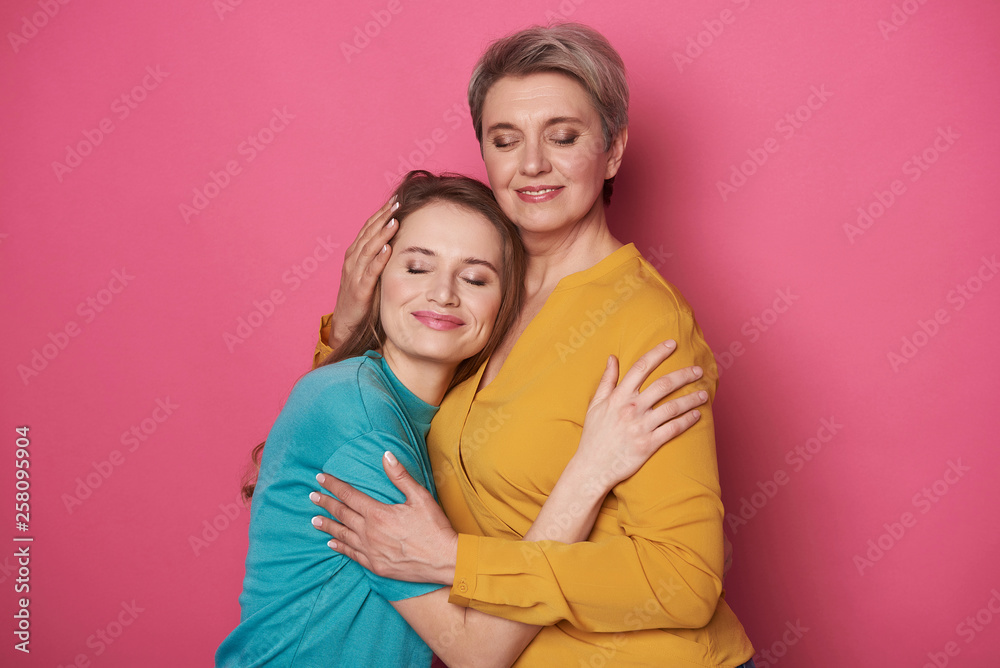 Beautiful Caucasian woman is pitying her daughter while posing for camera Beautiful Caucasian woman is pitying her daughter while posing for camera