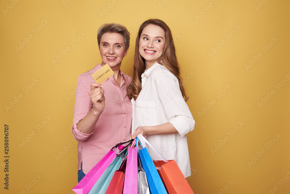 Waist up of happy Caucasian women after shopping posing for camera Waist up of happy Caucasian women after shopping posing for camera