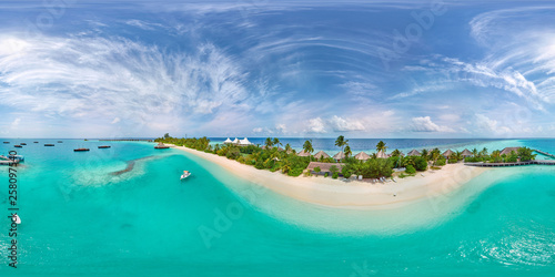 Fototapeta Naklejka Na Ścianę i Meble -  Aerial spherical panorama of tropical paradise beach  on tiny Maldives island. Turquoise ocean and white sand. Small bungalows between coconut palm trees
