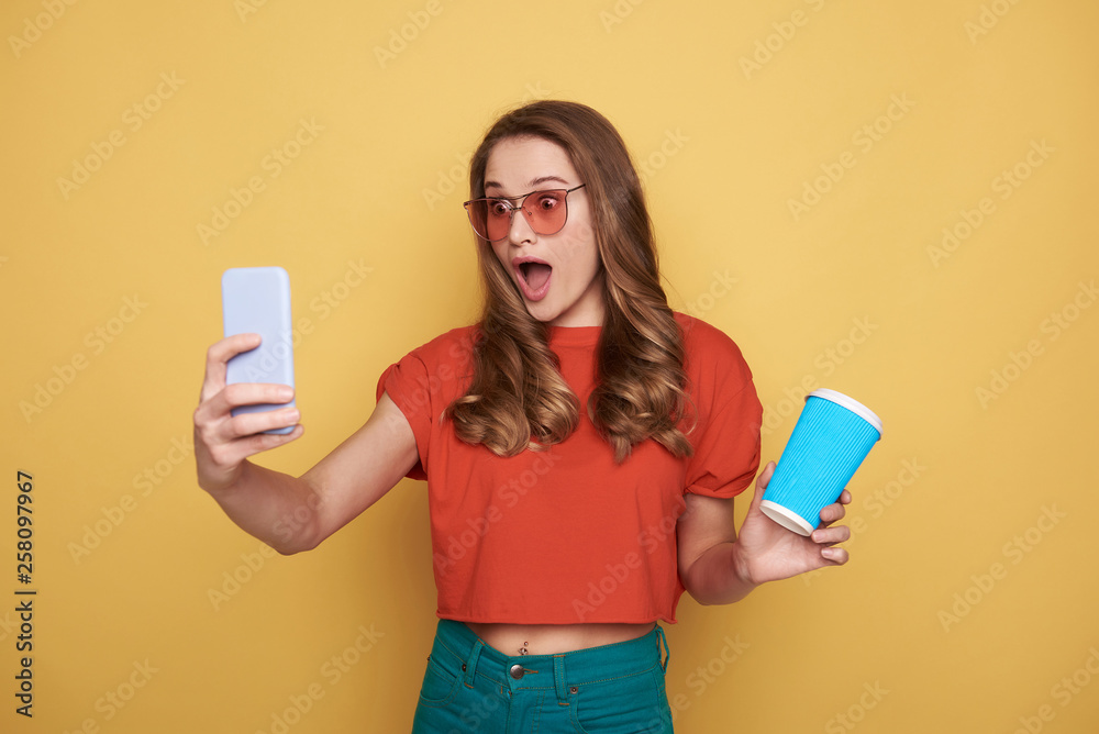 Waist up of surprised brunette young lady in eyeglasses posing for camera Waist up of surprised brunette young lady in eyeglasses posing for camera