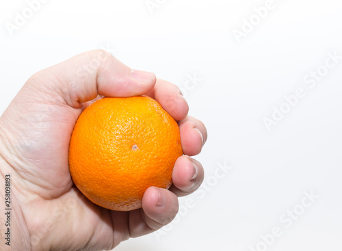 Squeeze an orange in hand Hold an orange in hand